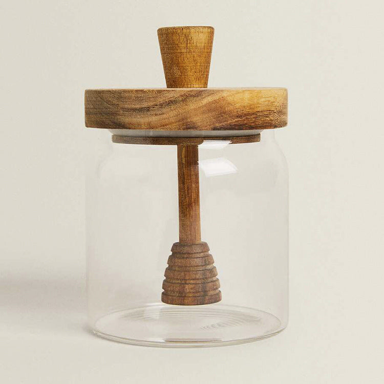 Pot à miel en verre avec couvercle en bois d'acacia de la marque Renfan, contenant un miel doré dans un design élégant.