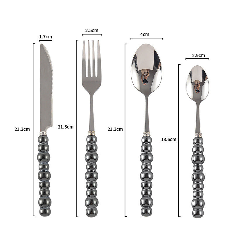Couvert en acier inoxydable VidaXL Athenes, set de couverts élégant avec fourchette, couteau et cuillère sur fond clair.