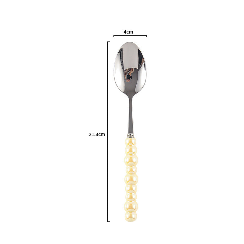 Couverts VidaXL Athenes en acier inoxydable, ensemble de fourchettes, couteaux et cuillères disposés sur une table.